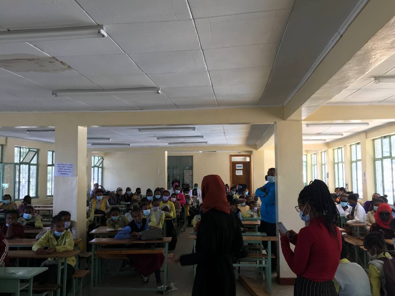 Participants seated at classroom desks during a group learning session.
